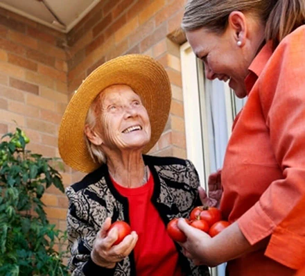A volunteer visitor and an older person in a garden